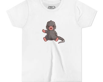 May include: White t-shirt with a cartoon illustration of a small, gray, spiky-haired creature with a pink nose and a happy expression. The text "ZOO GUIDE" is printed on the shirt.