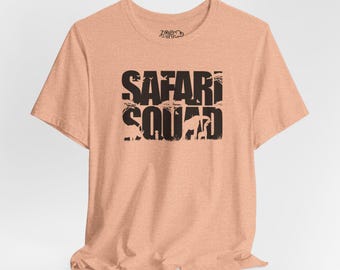 May include: A peach-colored t-shirt with a black graphic that says "SAFARI SQUAD" with animal silhouettes.