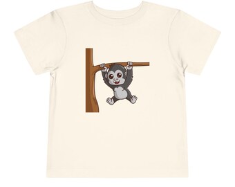 May include: A white t-shirt with a cartoon image of a monkey hanging from a tree branch.