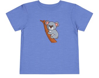 May include: A blue toddler t-shirt with a cartoon koala bear climbing a tree on the back.