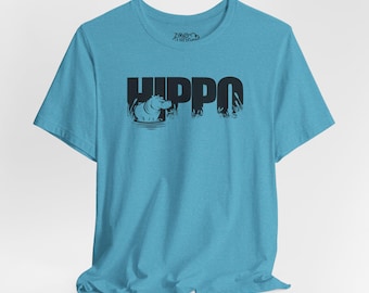May include: A light blue t-shirt with a black graphic of a hippopotamus in water with the word "HIPPO" printed above it.