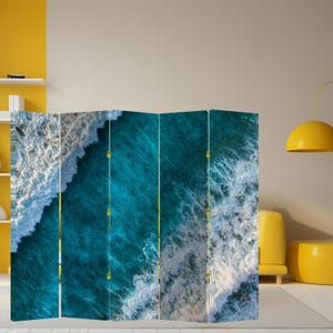 May include: A room divider featuring a vibrant ocean wave design. The artwork showcases shades of teal and white, creating a dynamic and calming aesthetic. The divider is a multi-panel screen, perfect for adding privacy or style to any space.