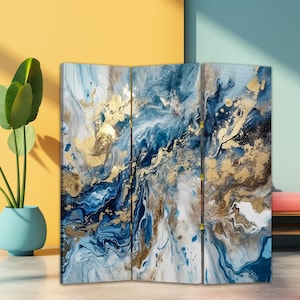 May include: A three-panel room divider featuring an abstract design with shades of blue, white, and gold. The artwork has a fluid, marbled appearance with gold leaf accents, creating a luxurious and artistic aesthetic.