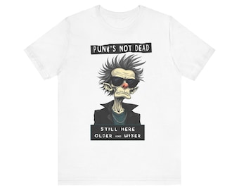 May include: White t-shirt with a cartoon punk rock character wearing sunglasses and a leather jacket. The text "Punk's Not Dead" is above the character and "Still Here Older and Wiser" is below.