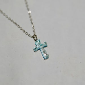 small cross necklace made of silver color dichroic glass