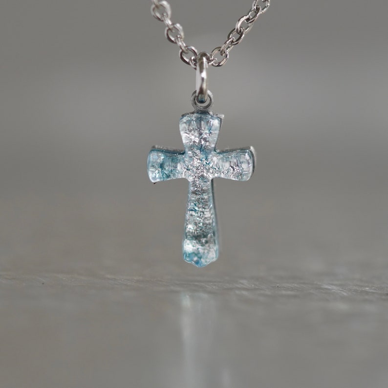 small cross necklace made of silver color dichroic glass