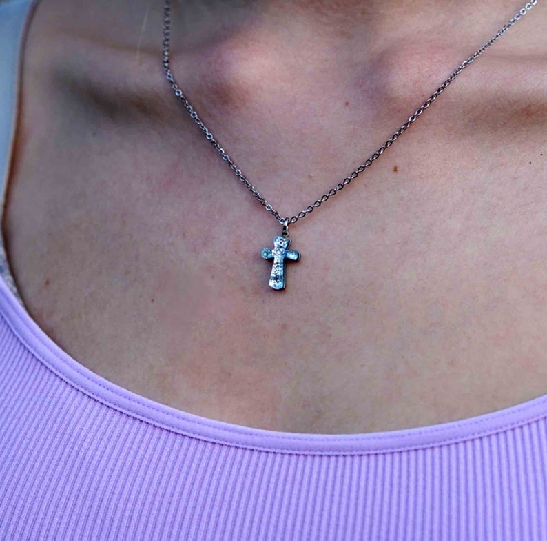 small cross necklace made of silver color dichroic glass