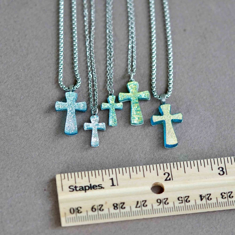 small cross necklace made of silver color dichroic glass