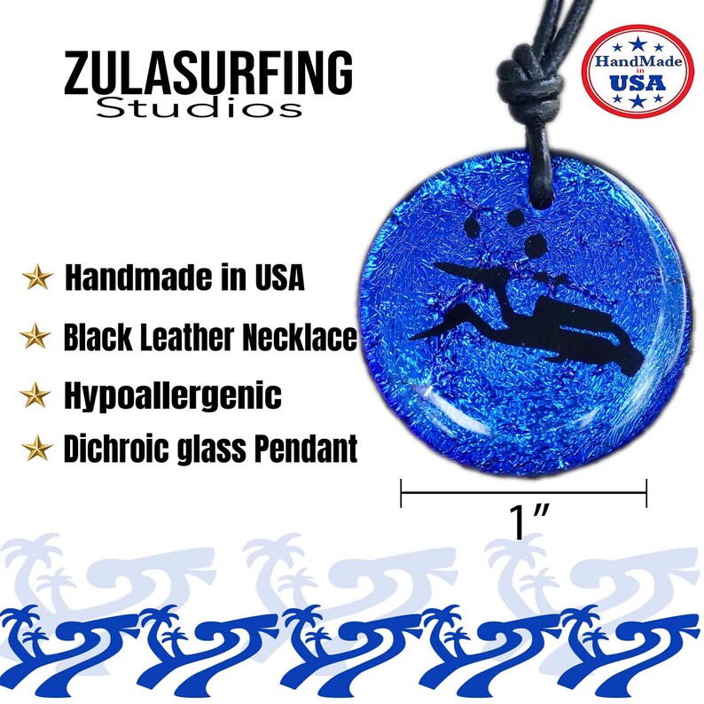 May include: A blue dichroic glass pendant featuring a silhouette of a scuba diver. The pendant is 1 inch in diameter and hangs from a black leather necklace. The pendant is handmade in the USA and is hypoallergenic.