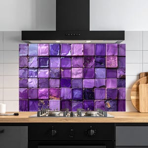 May include: A purple tile splashback with a square pattern above a gas hob. The tiles vary in shades of purple and have a marbled appearance. A black cooker hood is above the splashback.