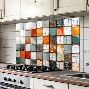 May include: A colorful kitchen backsplash featuring a mosaic of square tiles in various colors, including red, orange, green, and white. The tiles have a distressed, aged appearance, adding a rustic charm to the kitchen decor. The backsplash is installed above a stovetop.