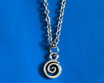 May include: A silver chain necklace with a small silver spiral pendant. The necklace is on a blue background.
