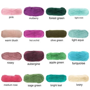 May include: A grid of yarn skeins in various colors, including pink, purple, green, and blue. Each skein is labeled with its color name, such as "pink," "mulberry," and "forest green." The yarn appears soft and suitable for knitting or crochet projects.