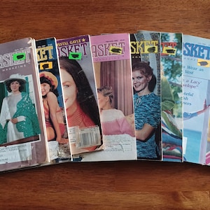 May include: A collection of eight vintage "Basket" magazines featuring various knitting and crocheting patterns. The magazines are from the 1970s and 1980s and feature colorful covers with images of women and children wearing knitted and crocheted garments.