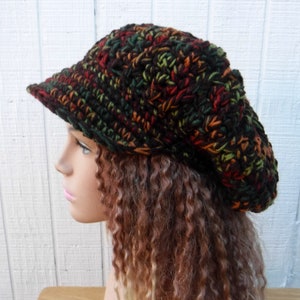 May include: A brown, green, and orange crocheted beanie with a brim. The beanie is slouchy and has a casual style.
