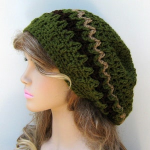 May include: A green crocheted beanie with brown and beige stripes. The beanie is slouchy and has a loose fit.