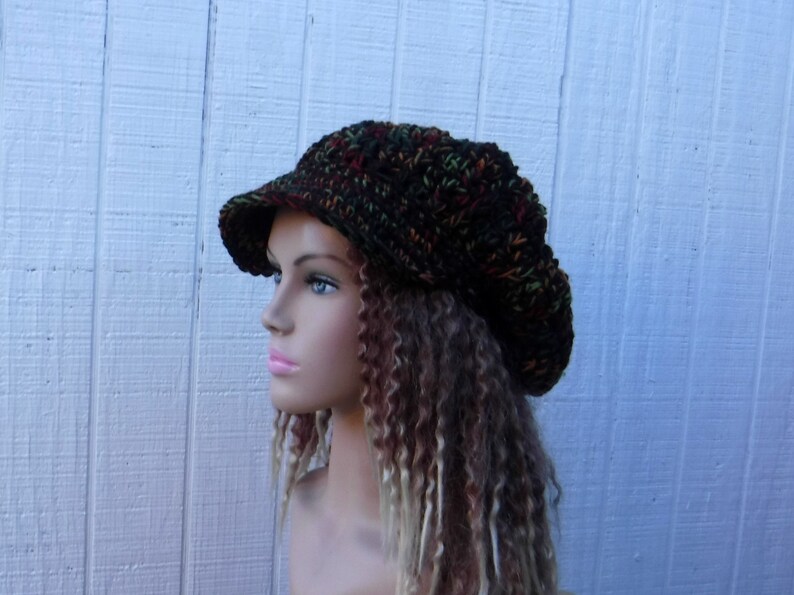 May include: A brown, green, and orange crocheted beanie with a brim. The beanie is slouchy and has a casual style.