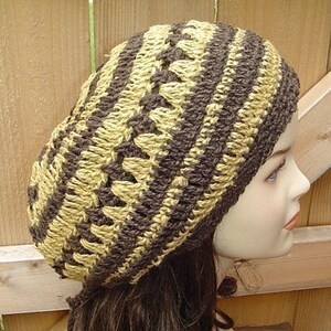 Peut inclure: Un bonnet crochet&eacute; brun et beige avec un motif ray&eacute;.