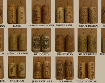 May include: A collage of 16 pairs of wine cork earrings, each pair featuring a different wine brand logo or design. The brands include Hess Dragons, Dare, Chateau Pontet Canet, Twisted Sister, Grape Design, 90+ Cellars, Robert Mondavi, Menage a Trois, Del Dotte, Franciscan, Select Green, Ferrari Carano, Joseph Phelps, Barefoot, Jessup Cellars, Paradigm, and The Joy of Wine.