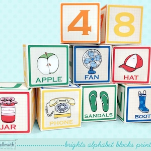 May include: A set of colorful alphabet blocks with illustrations and words on each side. The blocks feature words like "apple", "fan", "hat", "jar", "phone", "sandals", and "boot".