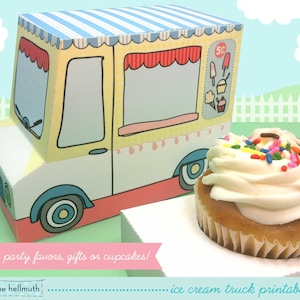 May include: A printable ice cream truck party favor box with a yellow, blue, and red design. The box is decorated with a cupcake, ice cream cone, and ice cream bar. The text "5C" is printed on the side of the box. The box is sitting on a white surface with a cupcake on top.