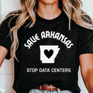 May include: Black t-shirt with the text "SAVE ARKANSAS" arched above a white outline of the state with a black heart in the center. Below the state outline, the text reads "STOP DATA CENTERS".