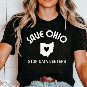 Könnte beinhalten: Dunkelgraues T-Shirt mit dem Text "SAVE OHIO" über einer weißen Umrisslinie des Bundesstaates Ohio mit einem schwarzen Herzen in der Mitte. Darunter steht der Text "STOP DATA CENTERS".
