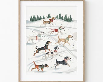 May include: A framed watercolor print featuring a winter scene with several dogs running through the snow. The dogs are various breeds and colors, each wearing a scarf or collar. Evergreen trees are in the background.