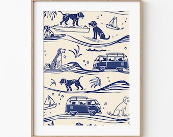 May include: A framed print featuring a repeating pattern of dogs, sailboats, and vans in navy blue on a cream background. The dogs are depicted surfing, sitting, and riding in boats. The artwork has a whimsical, beachy theme.