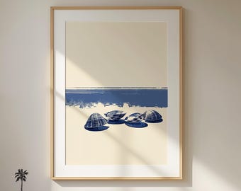 May include: Framed art print featuring a minimalist beach scene. The artwork depicts four blue seashells on a sandy shore, with a blue horizon line against a cream-colored sky. The frame is a light wood color. The text "Lucky Day Decor" is at the bottom.