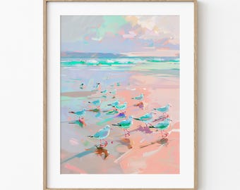 May include: A framed art print of a beach scene with seagulls. The artwork features a pastel color palette of pink, blue, and green. The seagulls are depicted in shades of blue and white, standing on the sandy shore near the ocean.