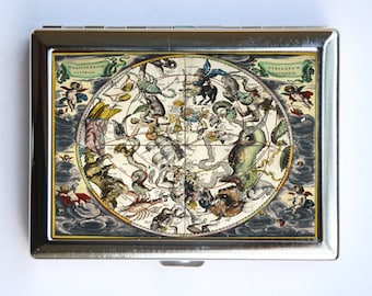 May include: A silver metal cigarette case with a vintage illustration of a celestial map. The map features constellations and stars with the text "STELLARVM ANTIQVVM" and "HAEMISPHERICVM AUSTRALE" in a banner.