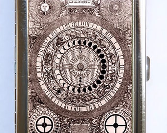 May include: A silver metal cigarette case with a vintage illustration of a celestial map with the text "Infommens des Himmels lauf bis vff 1XXXX jar".