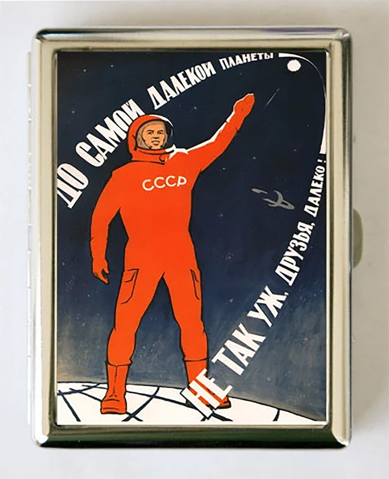May include: A vintage Soviet propaganda poster featuring an astronaut in an orange spacesuit standing on a planet with the text "To the most distant planet, friends, it's not so far!" in Russian.
