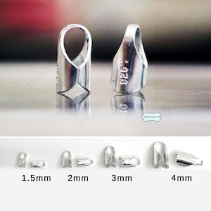 May include: Close-up of several silver-colored crimp end findings for jewelry making. The image shows various sizes, including 1.5mm, 2mm, 3mm, and 4mm. The findings have a loop at the top and a crimp section at the bottom.