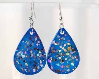 Bold blue resin teardrop dangle earrings with silver iridescent pink glitter sparkles