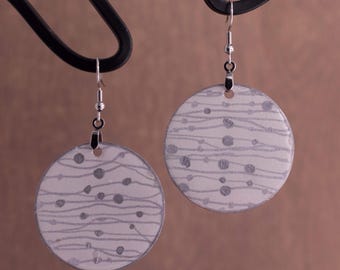 White and silver bold circular statement earrings