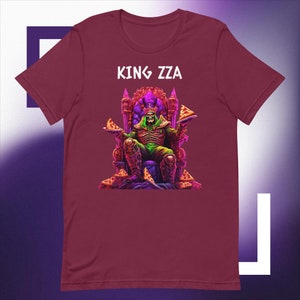 May include: A maroon t-shirt featuring a graphic of a skeletal figure wearing a crown and holding pizza slices. The text "KING ZZA" is printed above the graphic.