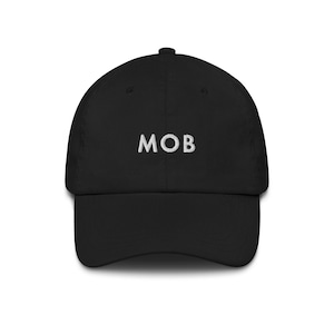 May include: Black baseball cap with the embroidered letters "MOB" in white. The cap has a curved brim and a structured crown. A classic, casual accessory.