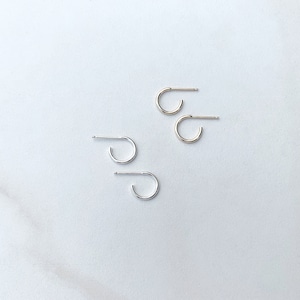 May include: Two pairs of small hoop earrings, one pair in gold and one pair in silver.