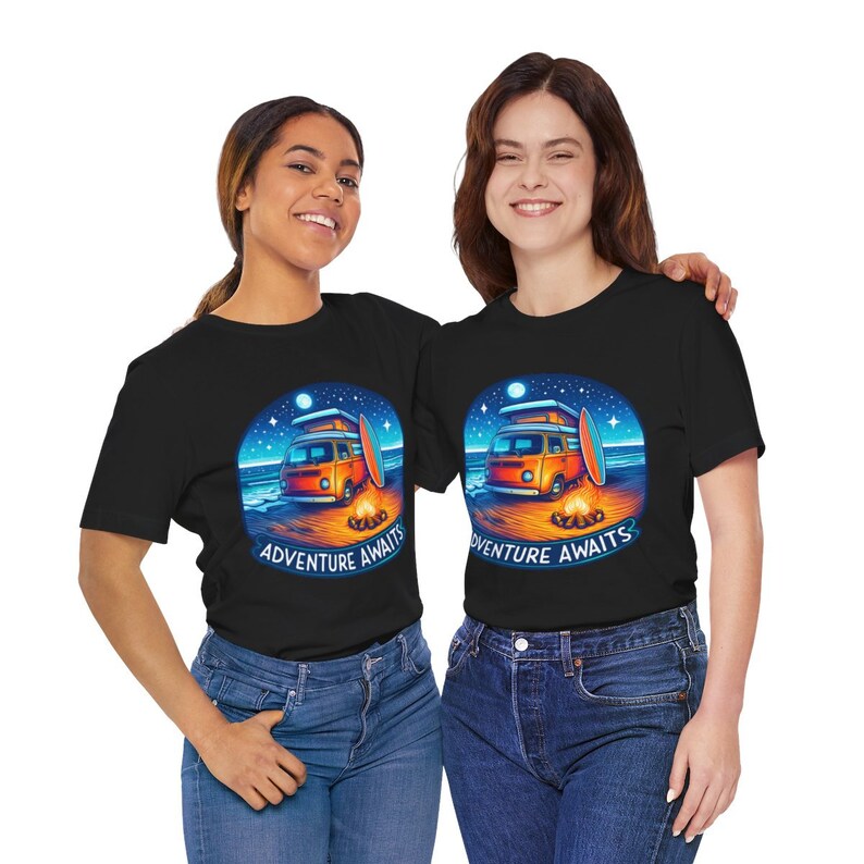 Two women wearing Adventure Awaits Camping T-Shirt, Perfect Gift for campers and digital nomads, Unisex Organic Soft Graphic T-Shirt, Fun and Chic T-Shirt in Black