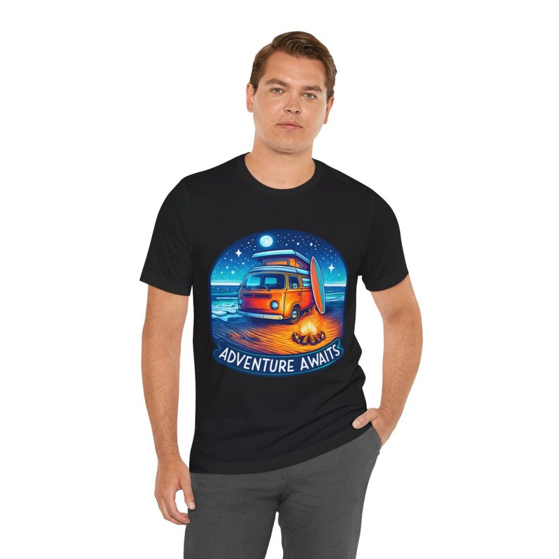 Man wearing Adventure Awaits Camping T-Shirt, Perfect Gift for campers and digital nomads, Unisex Organic Soft Graphic T-Shirt, Fun and Chic T-Shirt in Black