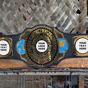 May include: A black championship belt featuring a large gold-colored central plate with the text INTERCONTINENTAL HEAVYWEIGHT CHAMPION, YOUR LOGO HERE, and two side plates with the text YOUR TEXT HERE and blue globe illustrations.