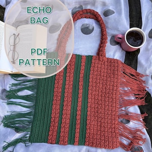 May include: A rectangular crochet tote bag featuring alternating vertical stripes of dark green and terracotta yarn. The bag has two matching handles and long, dangling fringe trim on both sides. Text on the image reads ECHO BAG PDF PATTERN.