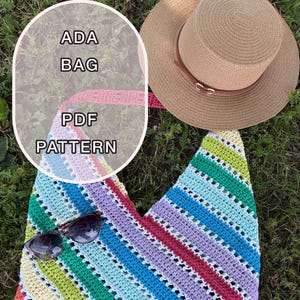May include: A crocheted bag with a colorful striped pattern in shades of red, purple, blue, green, and yellow. The bag is paired with a straw sun hat and sunglasses. Text on the image reads "ADA BAG PDF PATTERN."