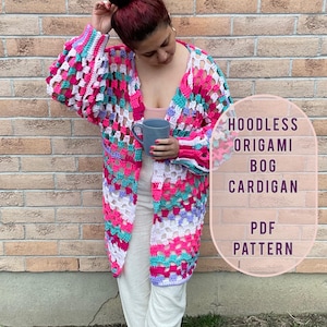 May include: A crochet cardigan with a colorful geometric pattern in shades of pink, purple, teal, and white. The cardigan is open in the front and has a relaxed fit. The text "HOODLESS ORIGAMI BOG CARDIGAN PDF PATTERN" is visible in the image.