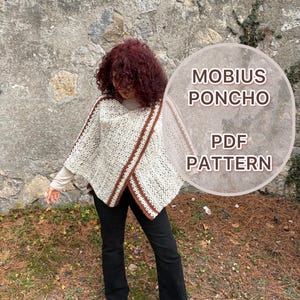 May include: A cream-colored crochet poncho with brown trim and the text "MOBIUS PONCHO PDF PATTERN" in a circular graphic. The poncho is worn over a long-sleeved shirt and black pants. The background is a stone wall.