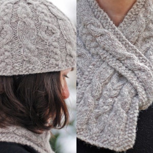 May include: A gray knitted hat and matching scarf with a cable knit pattern.
