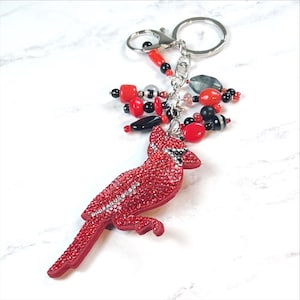 Llavero/dije para bolso con cuentas de cristal rojo y negro de cardenal