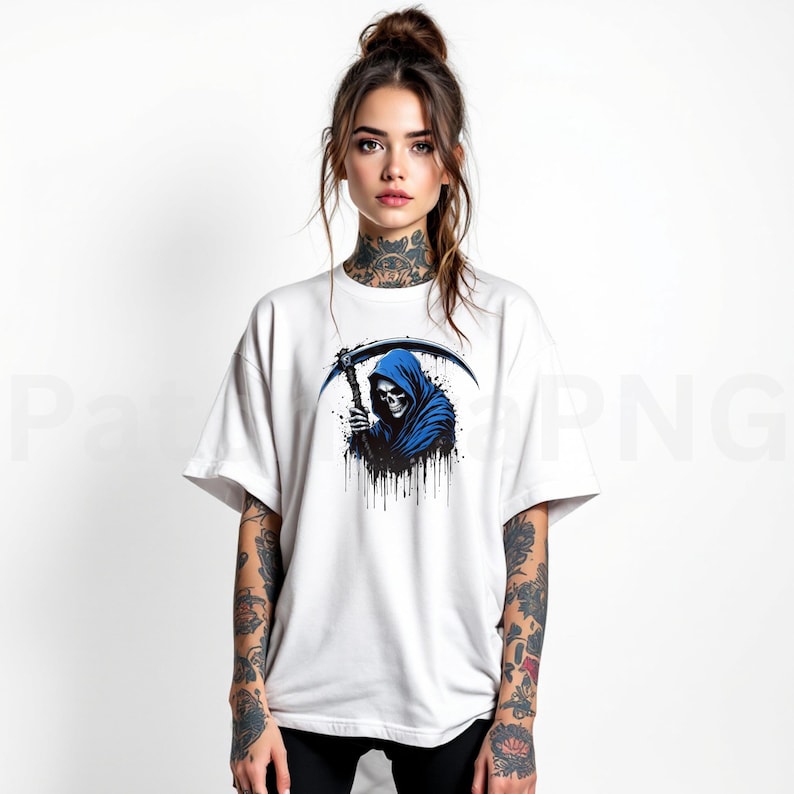 May include: White t-shirt featuring a blue Grim Reaper graphic. The design shows the Grim Reaper in a blue hooded cloak holding a scythe. The graphic has black dripping paint details. The shirt is a casual, oversized fit.